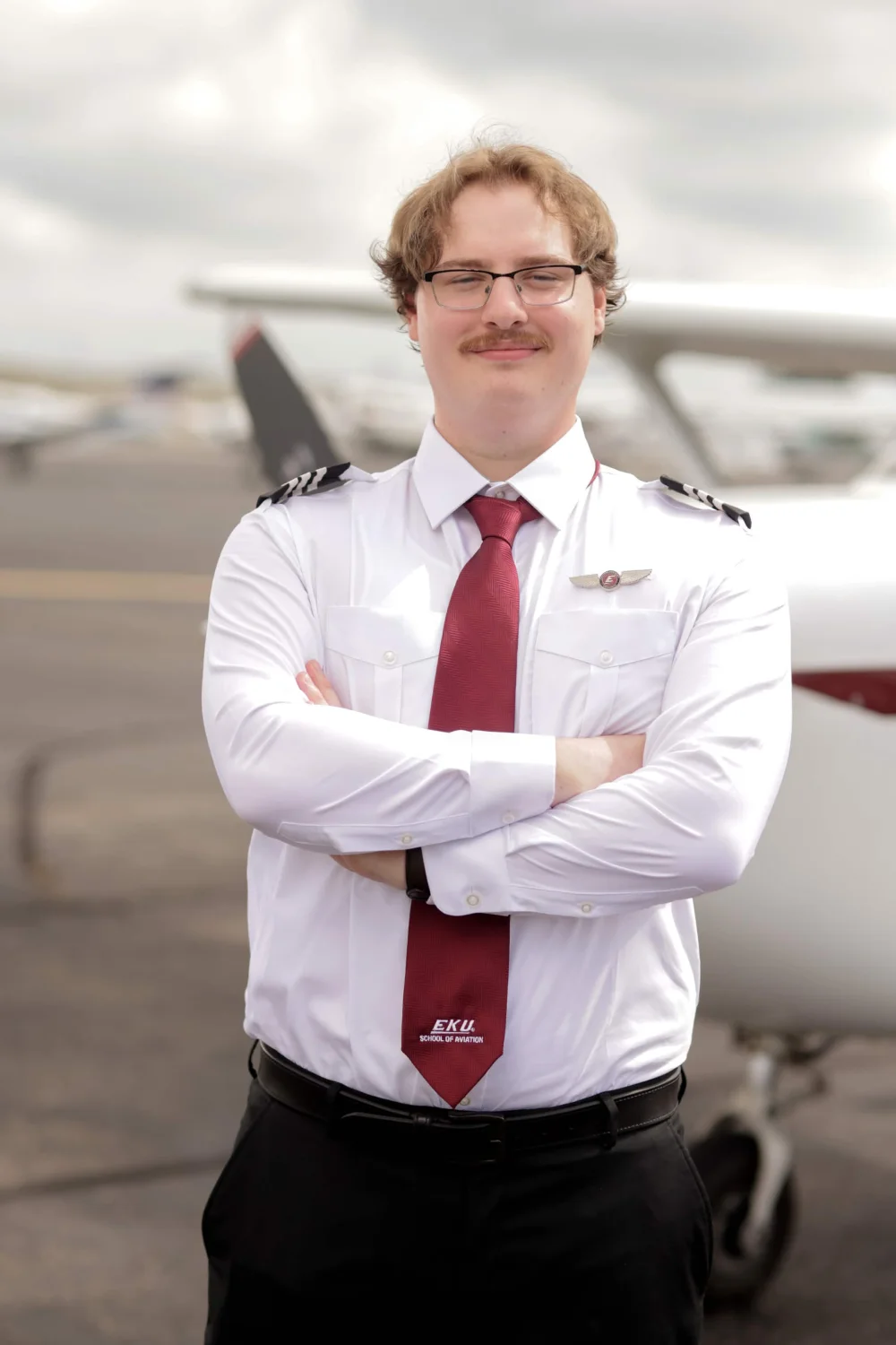 Ethan Markert standing in front of an aircraft